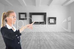 Composite image of businesswoman pointing somewhere