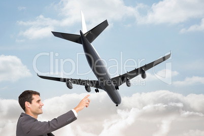 Composite image of smiling classy businessman sitting and pointi