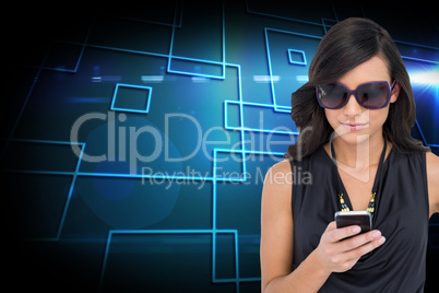 Composite image of happy brunette using smartphone