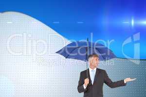 Composite image of happy businessman holding umbrella