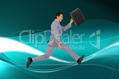 Composite image of businessman running with a suitcase