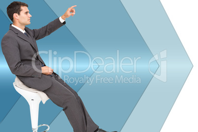 Composite image of businessman sitting and pointing the finger