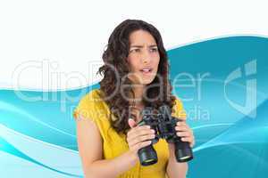 Composite image of serious casual young woman holding binoculars