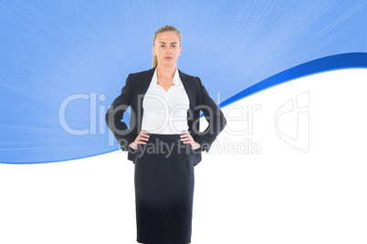 Composite image of businesswoman standing with hands on hips