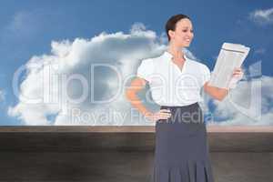 Composite image of cheerful stylish businesswoman holding newspa