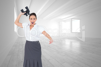 Composite image of angry businesswoman throwing binoculars away