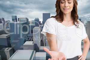 Composite image of attractive brunette presenting her hand