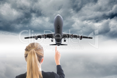 Composite image of businesswoman pointing somewhere