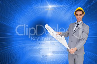 Composite image of serious architect with hard hat holding plans