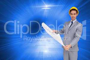 Composite image of serious architect with hard hat holding plans