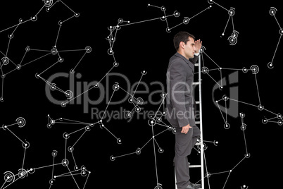 Composite image of stern businessman standing on ladder