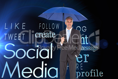 Composite image of businessman smiling at camera and holding blu