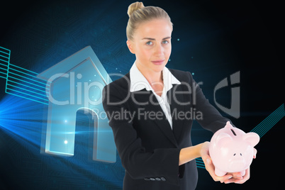 Composite image of businesswoman holding piggy bank