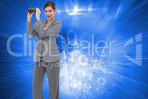 Composite image of businesswoman posing with binoculars