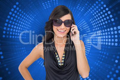 Composite image of happy brunette phoning