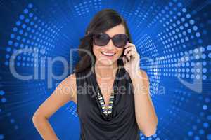 Composite image of happy brunette phoning