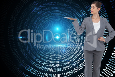 Composite image of businesswoman holding tablet computer