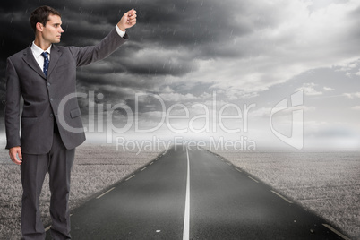 Composite image of stern businessman pointing