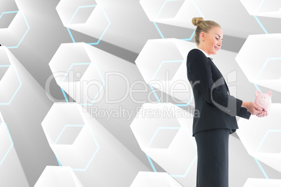 Composite image of businesswoman holding pink piggy bank Composite image of businesswoman holding pink piggy bank