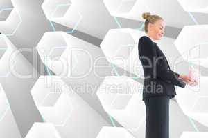 Composite image of businesswoman holding pink piggy bank