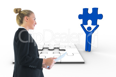 Composite image of businesswoman holding tablet