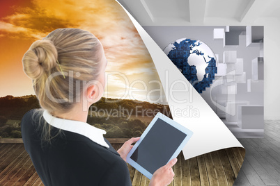 Composite image of businesswoman holding tablet