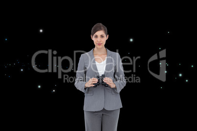 Composite image of young businesswoman with binoculars