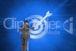 Composite image of businessman standing on ladder