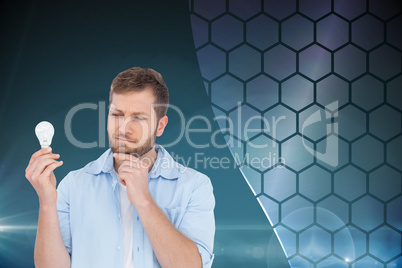 Composite image of sceptical model holding a bulb