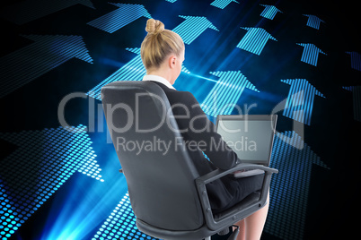 Composite image of businesswoman sitting on swivel chair with la