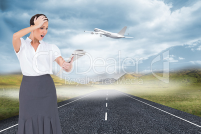 Composite image of surprised classy businesswoman holding newspa