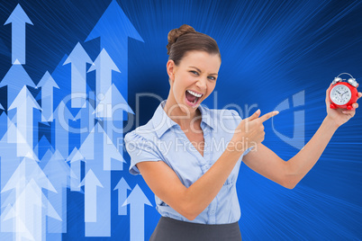 Composite image of businesswoman indicating alarm clock Composite image of businesswoman indicating alarm clock