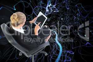 Composite image of businesswoman sitting on swivel chair with ta