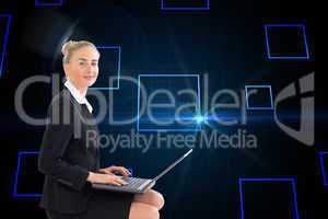 Composite image of businesswoman using laptop