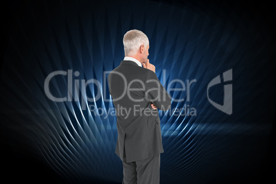 Composite image of thoughtful businessman standing back to camer