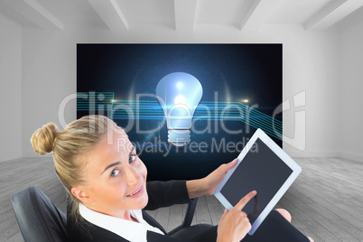 Composite image of businesswoman sitting on swivel chair with ta