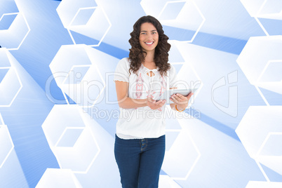 Composite image of smiling casual brunette using her tablet pc