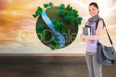 Composite image of attractive student holding books and her bag