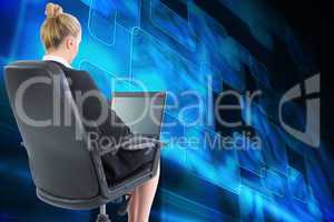 Composite image of businesswoman sitting on swivel chair with la