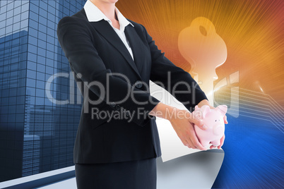 Composite image of businesswoman holding piggy bank