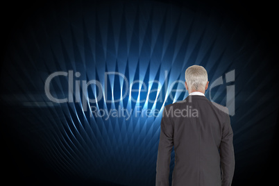 Composite image of businessman walking away from camera