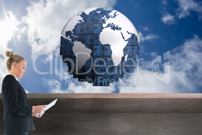 Composite image of businesswoman holding new tablet