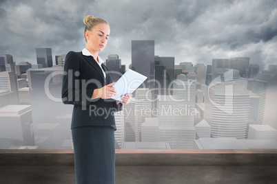 Composite image of businesswoman holding new tablet