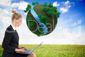 Composite image of businesswoman using laptop