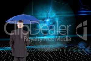 Composite image of businessman holding umbrella