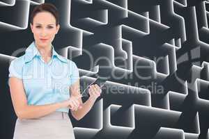 Composite image of serious classy businesswoman using calculator