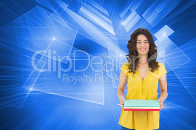Composite image of smiling curly haired brunette holding noteboo