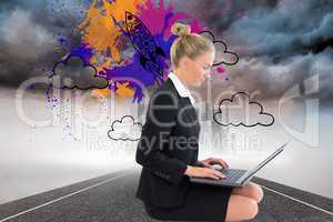 Composite image of businesswoman using laptop