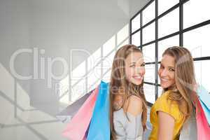 Composite image of two young women with shopping bags