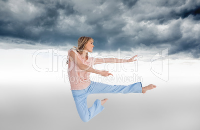 Composite image of woman doing dance pose